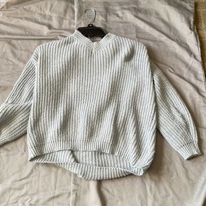 light blue cropped tie in the back sweater